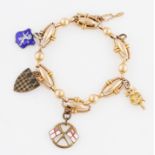 An oval link bracelet, suspending four various charms, to include three medallions and an imp,