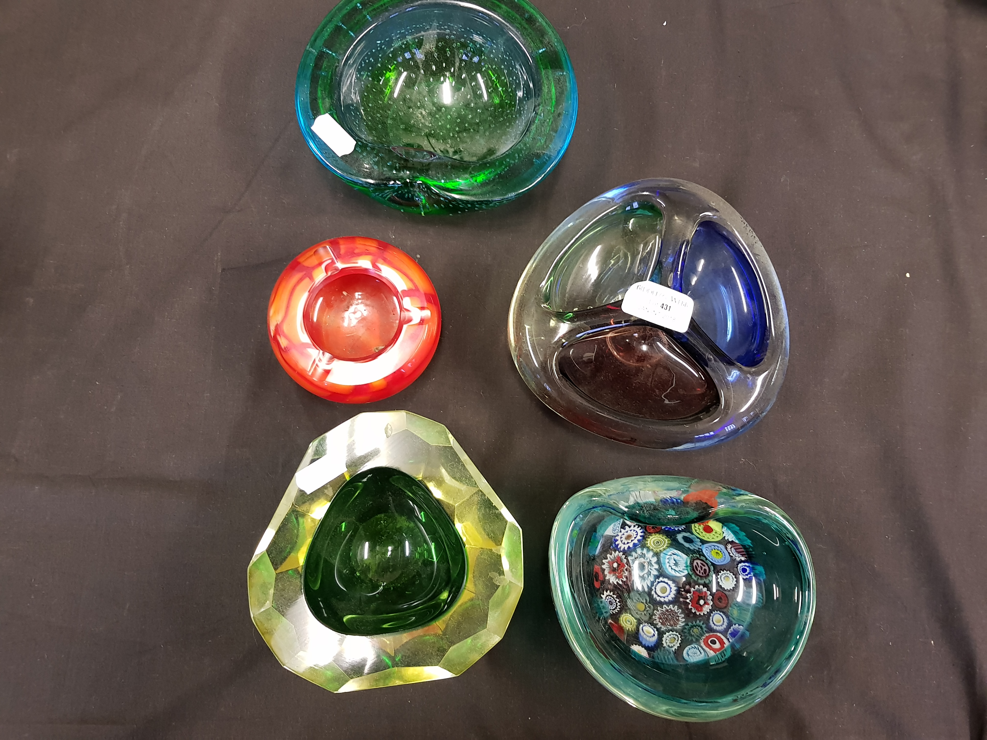 Five studio glass ashtrays, one with milleflori decoration.
