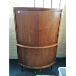 A teak four door corner cupboard