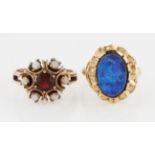 Two hallmarked 9ct yellow gold rings, one set with a central red paste surrounded by opal cabochons,