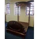 An early 19th century mahogany half tester bed with oval topped canopy.