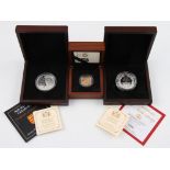 A 2013 Elizabeth II sovereign, together with a Prince George silver commemorative coin and a