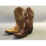 Two pairs of Frye cowgirl boots, one light brown with pink jewels, one dark brown with doves, size