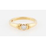 An 18ct yellow gold diamond solitaire ring, bezel set with a round brilliant cut diamond,