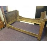 An oak French farmhouse style bed.