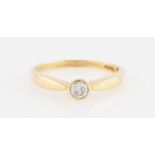 An 18ct yellow gold diamond solitaire ring, set with a round brilliant cut diamond, measuring