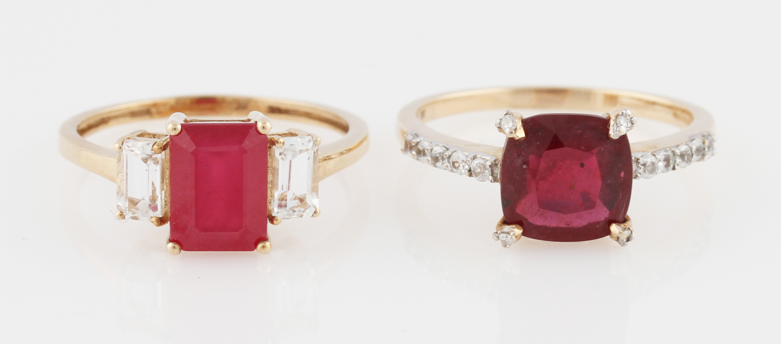 Two 9ct yellow gold ruby rings, set with additional colourless stones, both hallmarked Birmingham,