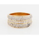 An 18ct yellow gold diamond half eternity ring, set with a central row of graduated tapered baguette