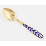 A Russian silver gilt enamel spoon.