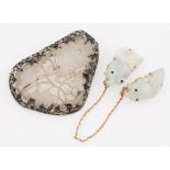 A carved white jade brooch with white metal frame featuring enamel decoration, stamped SILVER,