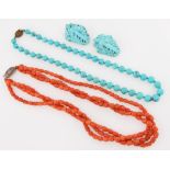 A string of turquoise beads together with a pair of carved turquoise dress clips, along with a