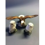 A Beswick 1018 bald eagle with two Royal Doulton snowy owls.