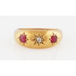 A Victorian 18ct yellow gold ruby and diamond three stone ring, star set with a central old cut