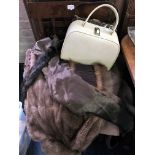 *A selection of various fur coats together with a cream handbag with brass clasp.