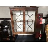 An Edwardian mahogany cabinet with glass panel doors.