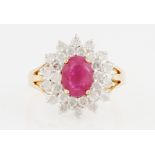 A 9ct yellow gold treated ruby and diamond cluster ring, set with an oval cut ruby, possibly glass
