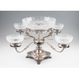 A silver and glass epergne centrepiece, with four branches supporting four glass bowls, with central