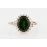 A 9ct yellow gold chrome diopside and diamond cluster ring, set with an oval chrome diopside