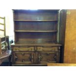 An oak kitchen dresser with barley twist to side.