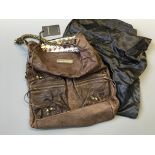 A Thomas Wylde brown distressed leather portobello skull bag with label and silk sack.