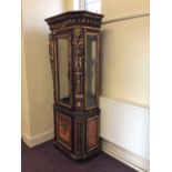 A Egyptian style display cabinet with embellished carved Pharaoh design to side.