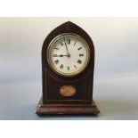 A mahogany cased mantel clock with inlay design.