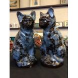 Two 'Ewenny Pottery' ceramic cats in mottled blue and brown design, engraved on base and label