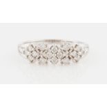 A 9ct white gold diamond ring, set with round brilliant and tapered baguette cut diamonds,