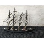 A black painted model ship.