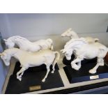 Four white Beswick horses on wood base, 'Spirit of Earth' and 'Spirit of Fire'.