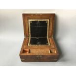 *A mahogany writing slope with black leather interior and exterior brass details.