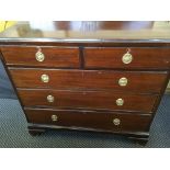 A mahogany chest of drawers, three long and two short drawers.