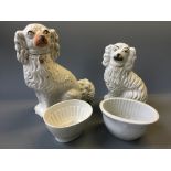 Two Staffordshire dogs with a box of jelly moulds.