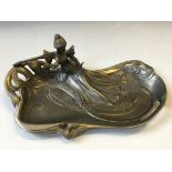 An Art Nouveau style tray with seated female reading.