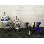 Two Chinese lamp bases together with a three branch chandelier with blue glass light shades.