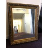 A large, gilt framed mirror, damage to gilding, 120.5cm x 90.2cm.