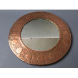 An arts & crafts style copper wall mirror. Diameter 45cm.