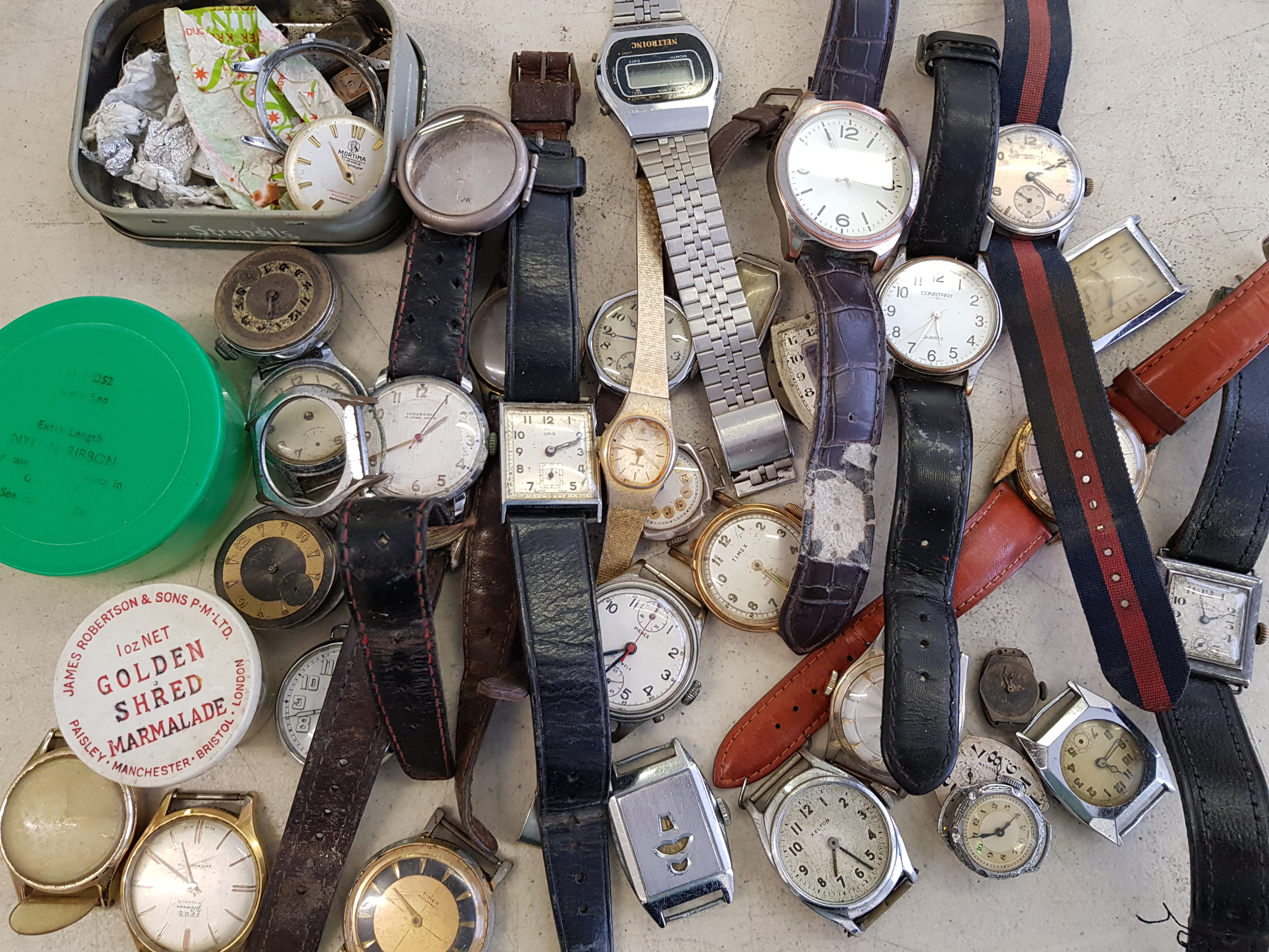 A collection of wrist watches and wrist watch parts.