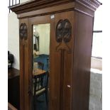 A Satinwood single door wardrobe with mirror and Art Nouveau decorative features.