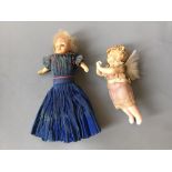 Two small wax dolls, one with crepe paper dress, one a winged cherub.