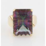 A 9ct yellow gold mystic quartz ring, set with a rectangular cut coated quartz, measuring approx.