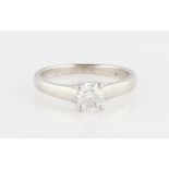 A platinum diamond solitaire ring, set with a round brilliant cut diamond measuring approx. 0.