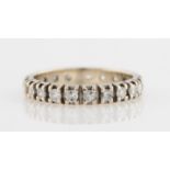 A diamond full eternity ring, set with 21 diamonds, some round brilliant cut and some old cut,