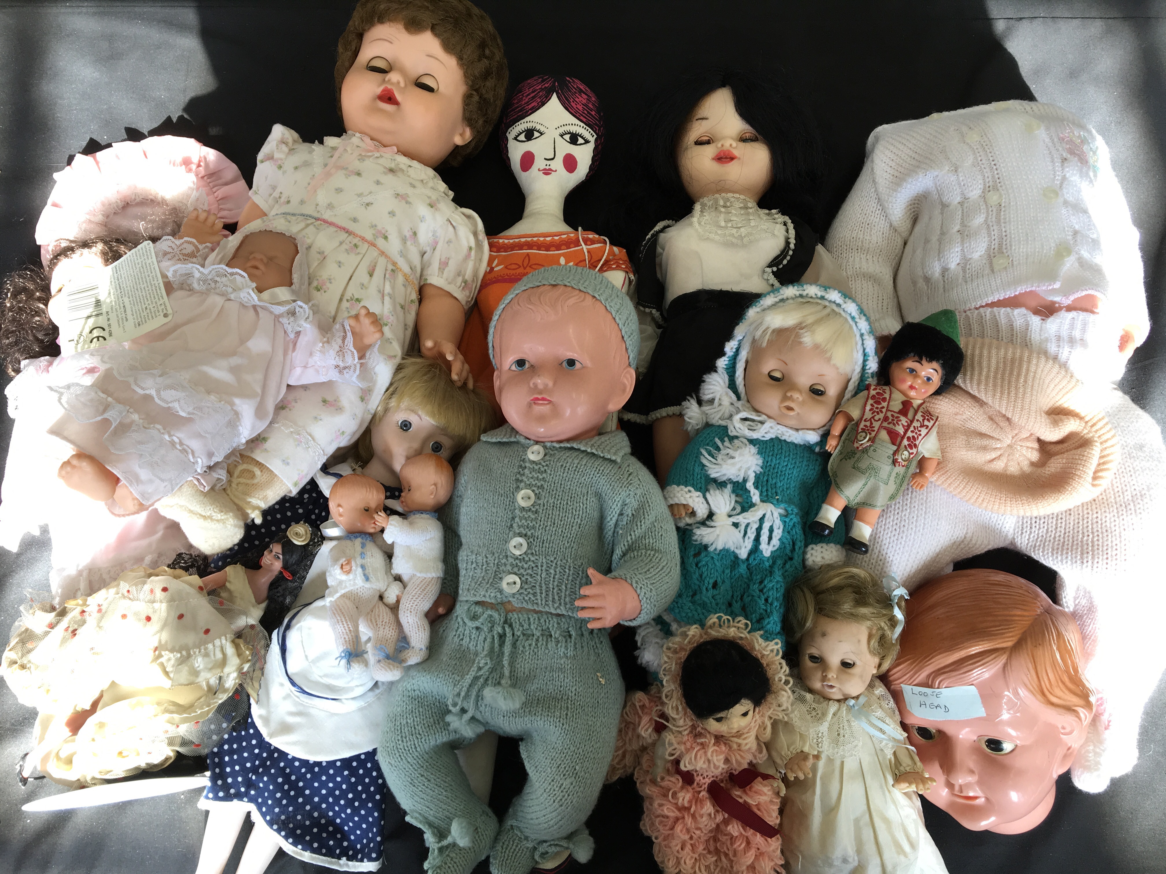 Fifteen various dolls including a stuffed doll, miniature flamenco dancers, standing porcelain doll,