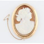 A cameo brooch, featuring a ladies portrait in profile, in a yellow metal frame stamped 9ct,