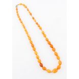 A string of butterscotch amber beads, comprising approx. 43 graduated oval beads, weight approx.