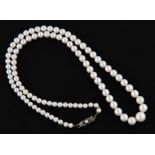 A string of graduated pearls, clasp stamped 935, housed in a fitted Mikimoto Pearls Lane Crawford’