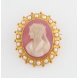 A Victorian cameo brooch, featuring carved ladies portrait in profile on purple hardstone