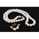 A string of pearls, diameters approx. 7mm, clasp stamped 750, length approx. 43cm, together with a
