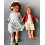 Two dolls, one with wooden arms.